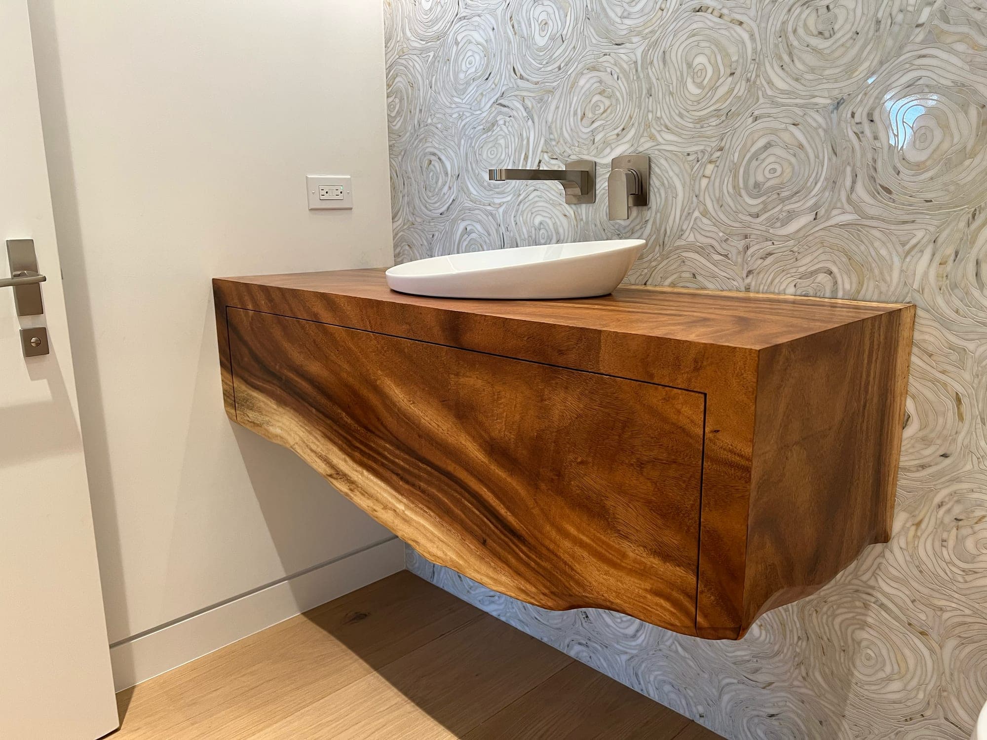 Heritage American Woodworks: a floating hardwood vanity with a live edge and a vessel sink
