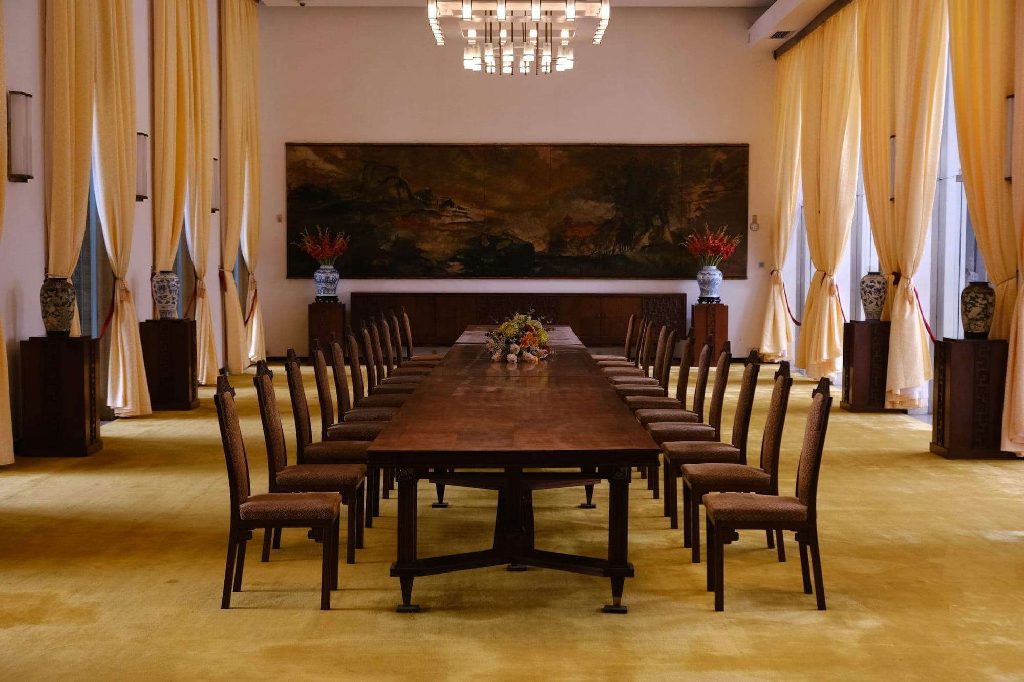 A fourteen-seat solid wood table in a formal room
