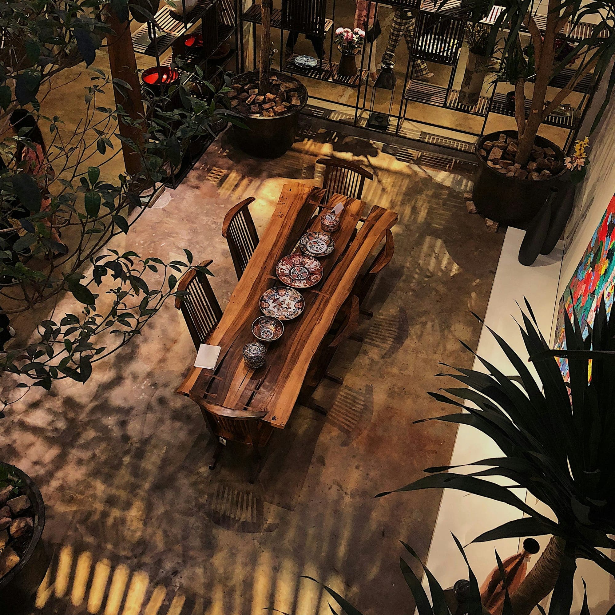 A single-slab table on a solid base in a courtyard, seen from above