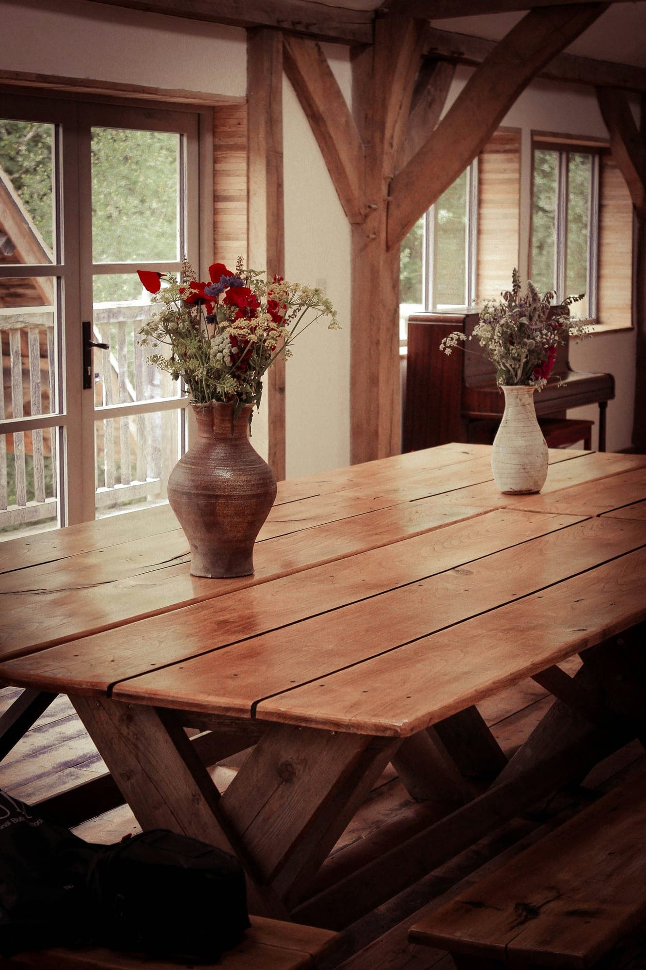 A weighty farmhouse table under a timber frame