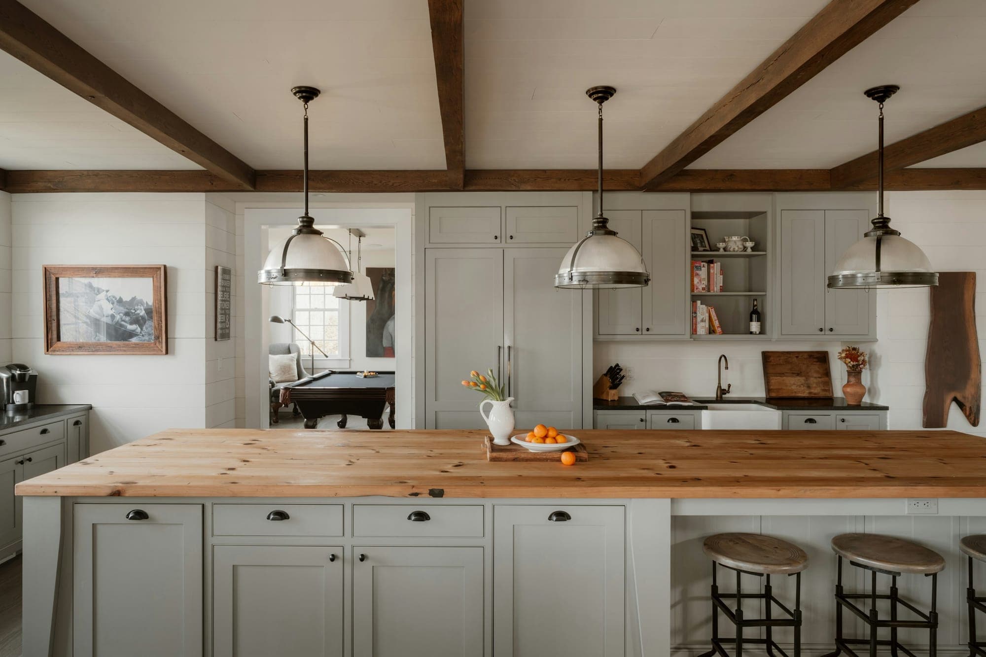 A butcher block island top under exposed beams