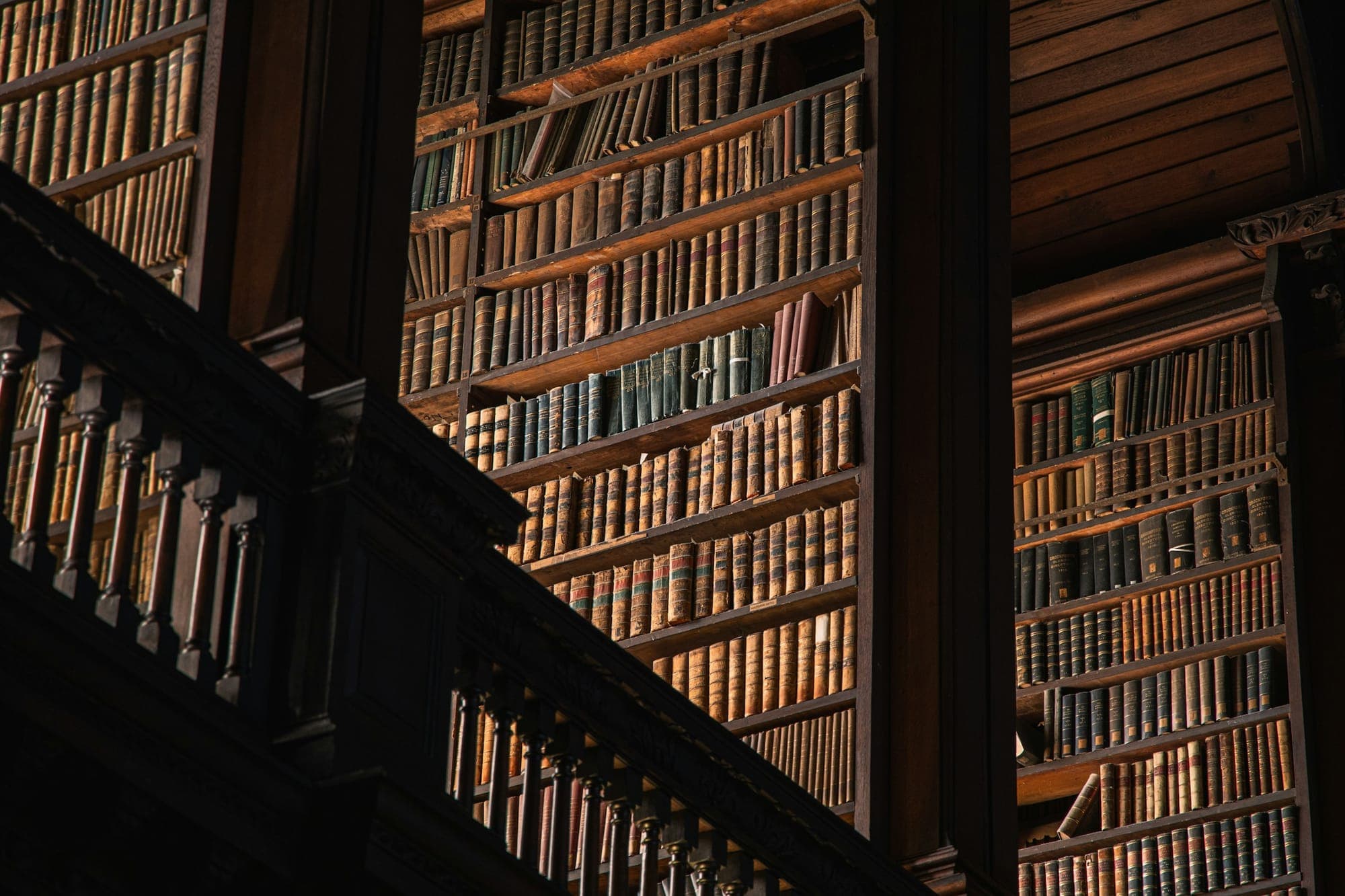 A two-storey library with a wooden gallery rail